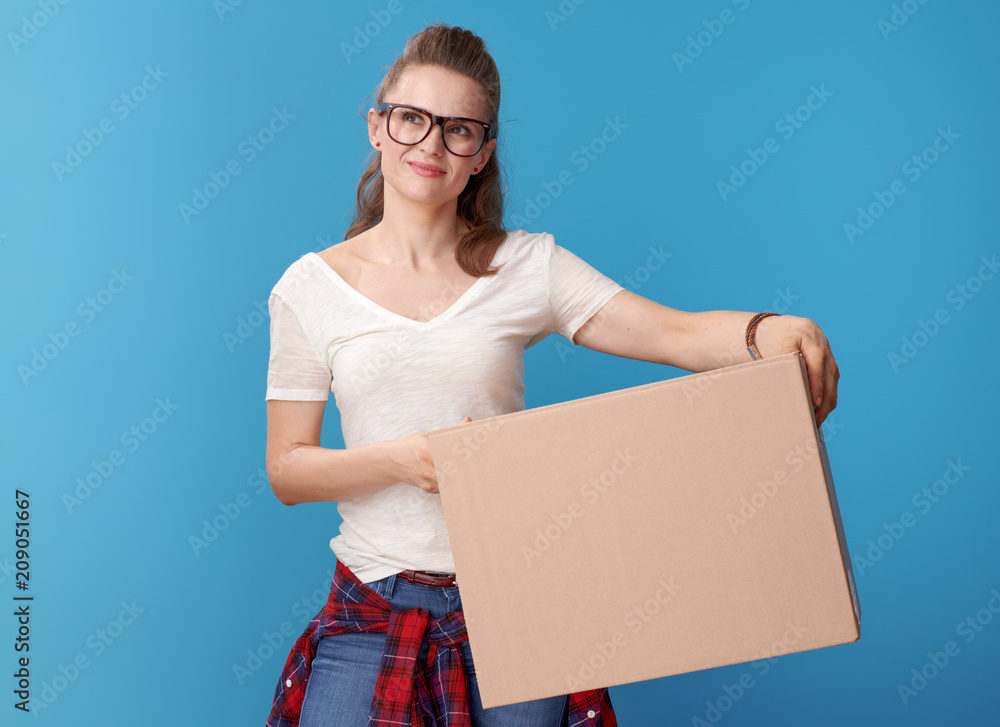 pensive modern hipster with cardboard box on blue pensive modern hipster with cardboard box on blue