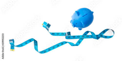 Piggy bank, blue with measure tape and copy space, isolated on white background, banner,