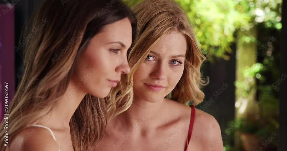 Pair of lovely young ladies gazing off into the distance together outside, Young blonde female looks at the camera while her brunette friend stares off into the distance, 4k Pair of lovely young ladies gazing off into the distance together outside, Young blonde female looks at the camera while her brunette friend stares off into the distance, 4k