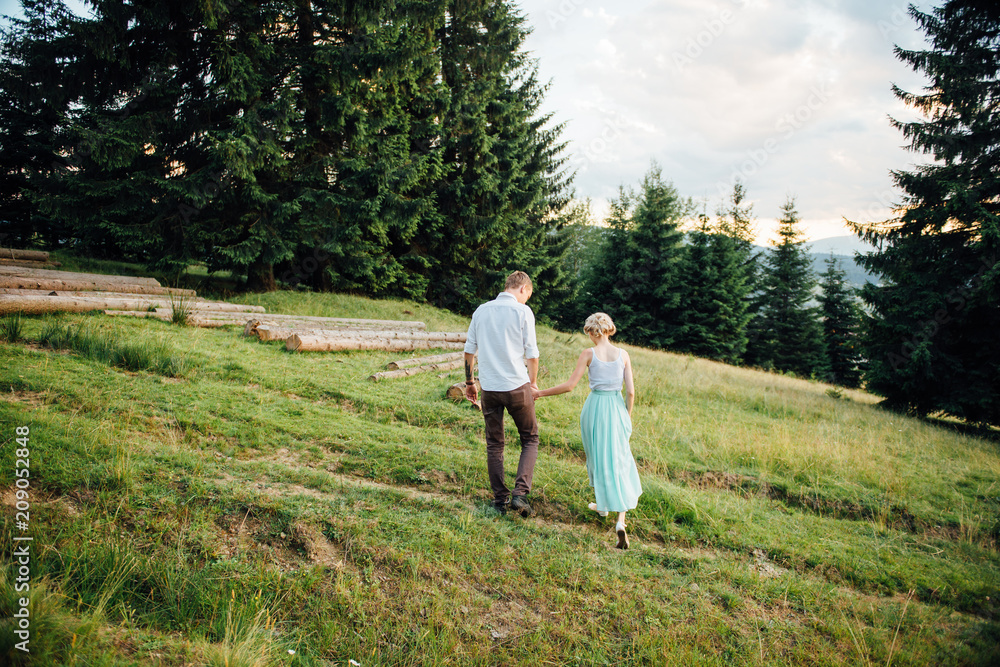 Couple in love walking in the mountains, having fun