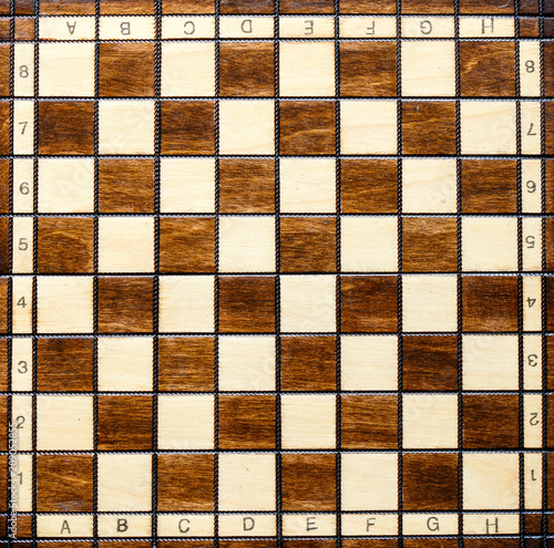 Chess board. Wooden chess board. Chess board background. Chessboard brown pattern.