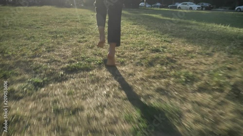 Wallpaper Mural Silhouette of young extraordinary happy bold girl is running on lawn in park in daylight, in summer, heathy lifestyle Torontodigital.ca