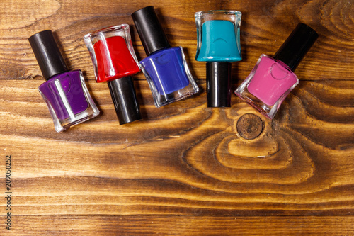 Set of nail polish bottles on wooden background