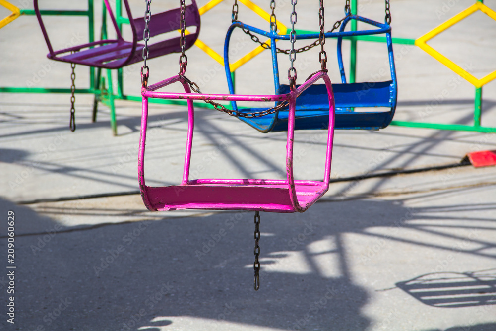Empty colorful seats of children's carousel in the amusement park. Empty colorful seats of children's carousel in the amusement park.