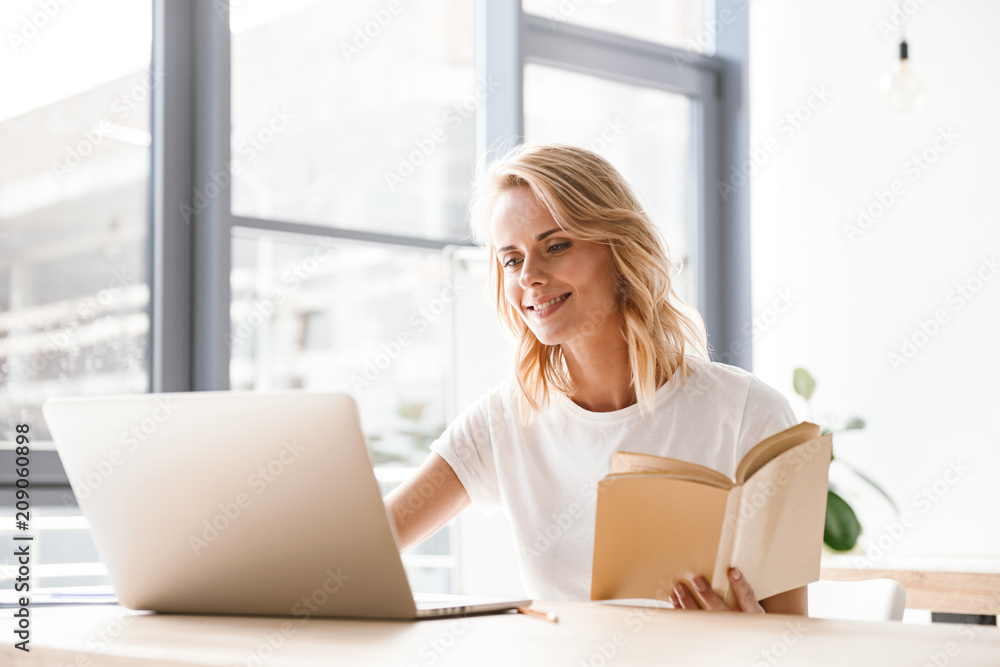 Smiling businesswoman working on laptop computer Smiling businesswoman working on laptop computer