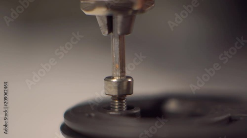 Close up. The man twists the screw bolt. Screwdriver man's hand tightening a bolt. 4K