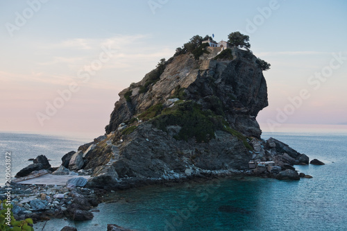 Fototapeta The church of Agios Ioannis Kastri on a rock at sunset, famous from Mamma Mia mo
