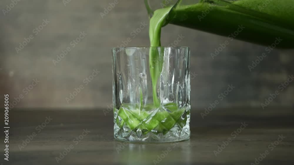 Pouring fresh green smoothie in a glass Pouring fresh green smoothie in a glass