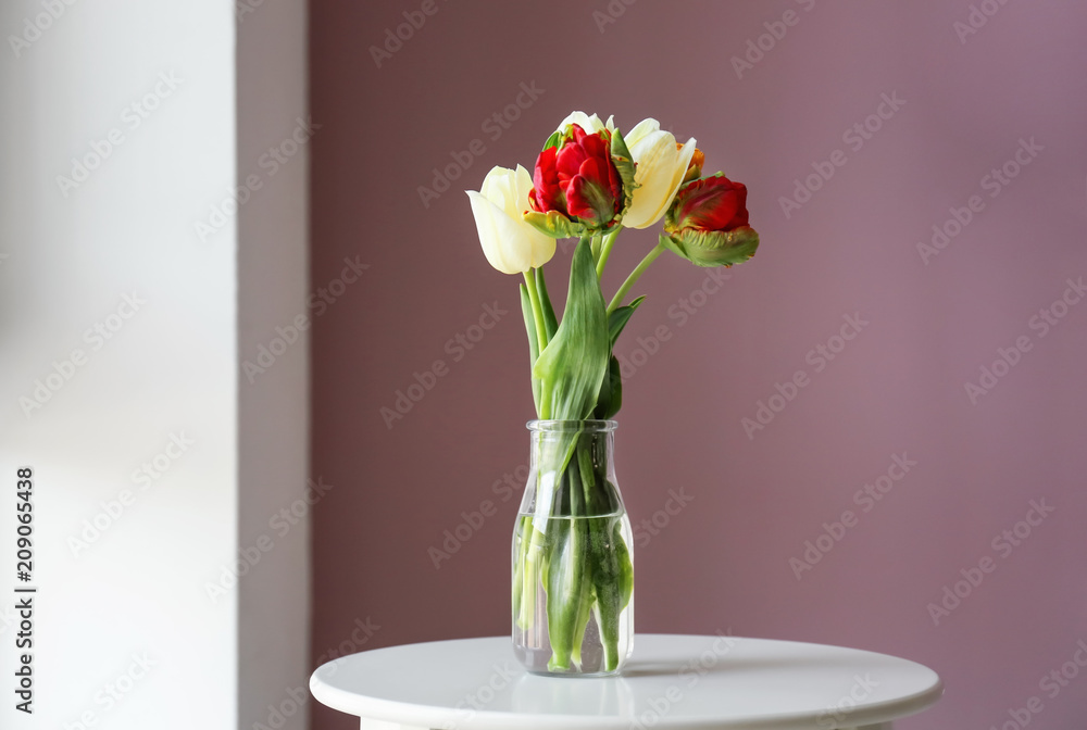 Vase with beautiful tulips on table indoors