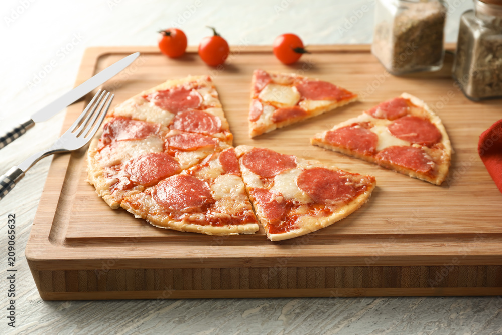 Pieces of pepperoni pizza on wooden board Pieces of pepperoni pizza on wooden board