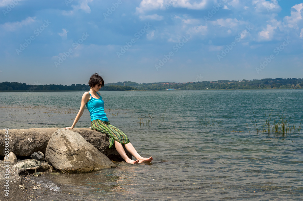 Beautiful young Caucasian woman cooling off in the lake on a summer day in Sapanca, Turkey
