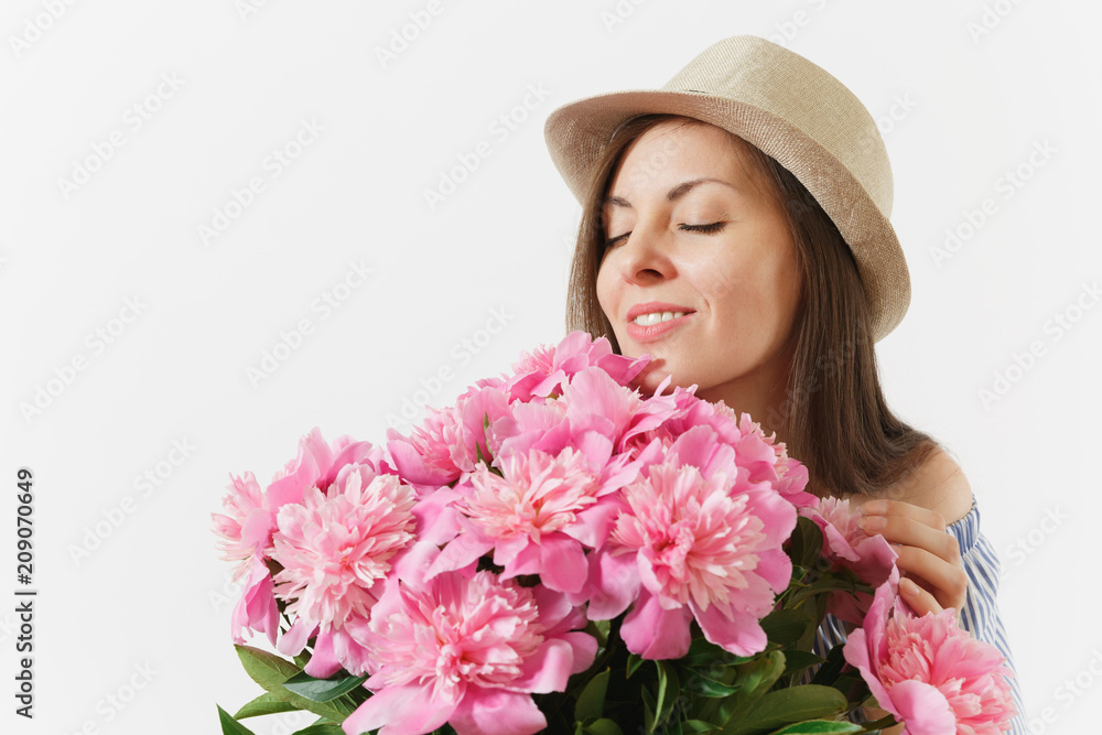 Fototapeta premium Close up young tender woman in dress hat holding, sniffing bouquet of pink peonies flowers isolated on white background. St. Valentine's Day International Women's Day holiday concept. Advertising area