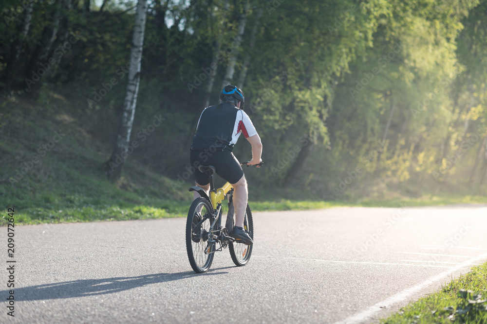 triathlete cycling on a bicycle at the training road in Moscow