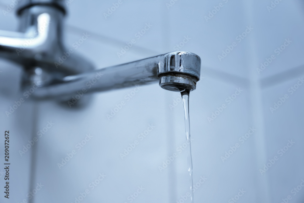 Water pouring from tap, closeup. Water saving concept Water pouring from tap, closeup. Water saving concept