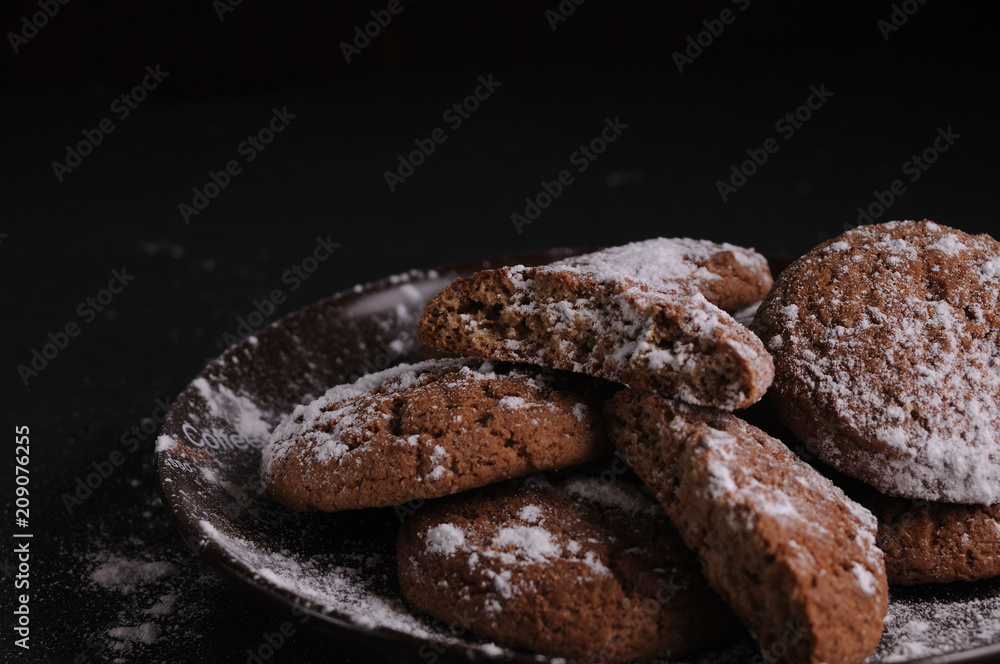 oatmeal cookies on a black table in castor sugar oatmeal cookies on a black table in castor sugar