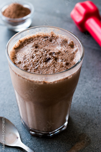 Chocolate Protein Shake Smoothie with Whey Protein Powder and Red Dumbbells