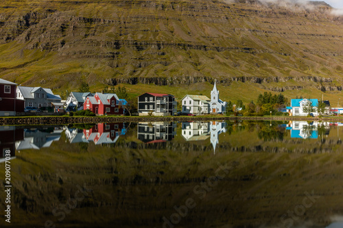 Buildings and backdrop reflected in water at Seydisfjordur, Iceland