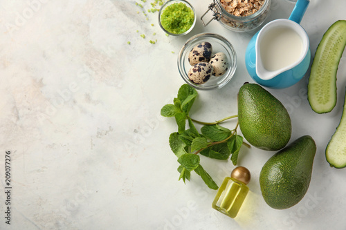 Avocado with ingredients for natural homemade cosmetics on light background