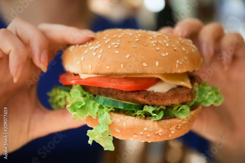 Woman holding tasty burger  closeup