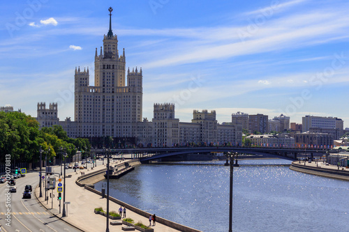 View of Bolshoy Ustyinskiy bridge on a background of skyscraper on Kotelnicheskaya embankment on a sunny summer morning photo