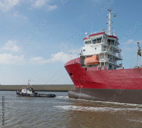 Freightship with towboat. Netherlands. Harbor. Coaster photo