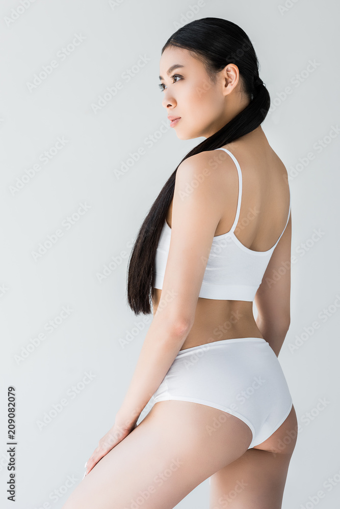 slim beautiful seductive asian woman in white underwear, isolated