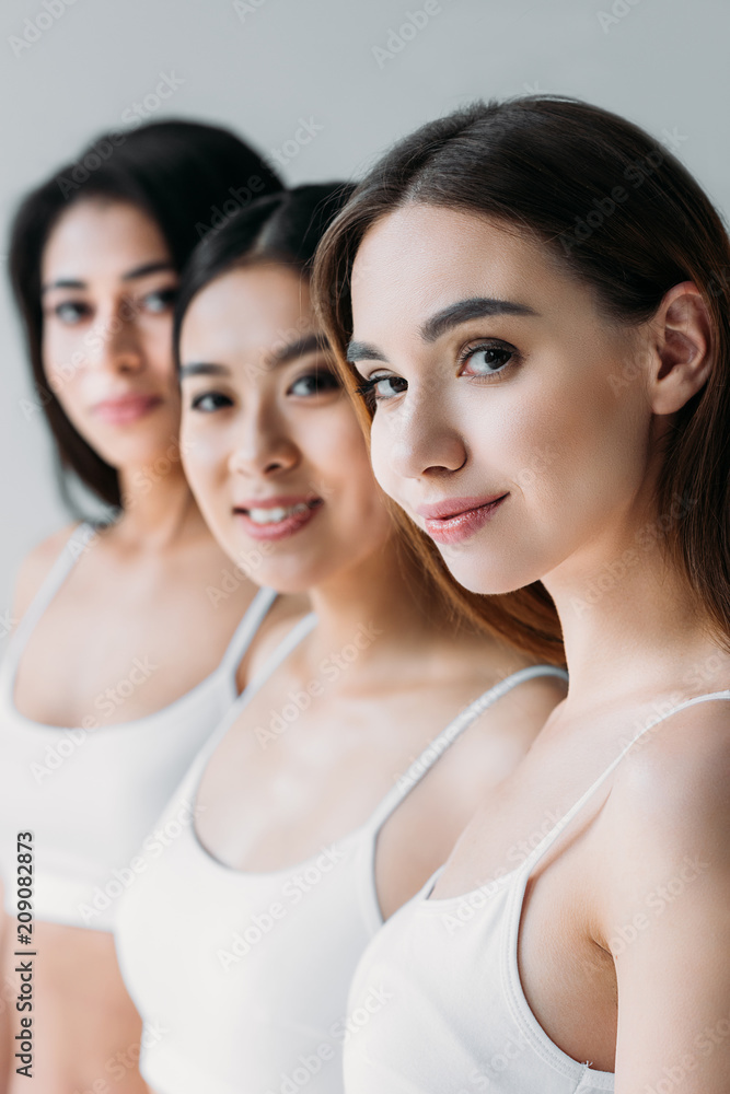 beautiful multiethnic girls looking at camera, isolated on grey beautiful multiethnic girls looking at camera, isolated on grey