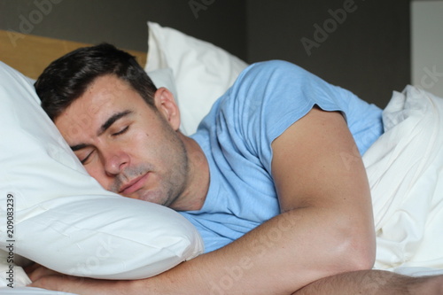 Man deeply sleeping in comfy bed