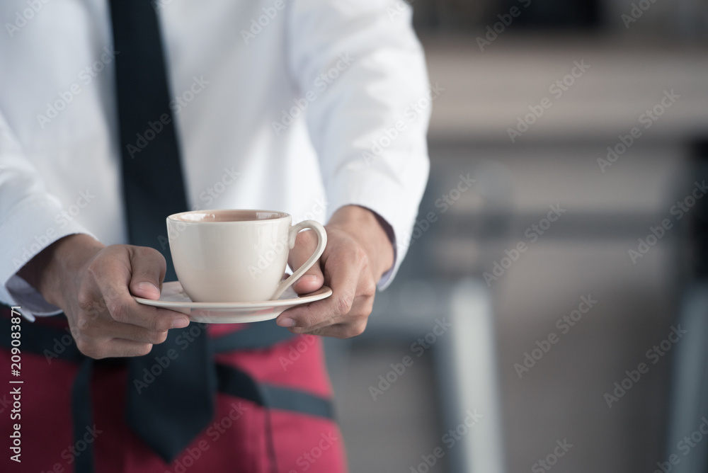 Close up of waiter serving coffee in cafe. Close up of waiter serving coffee in cafe.