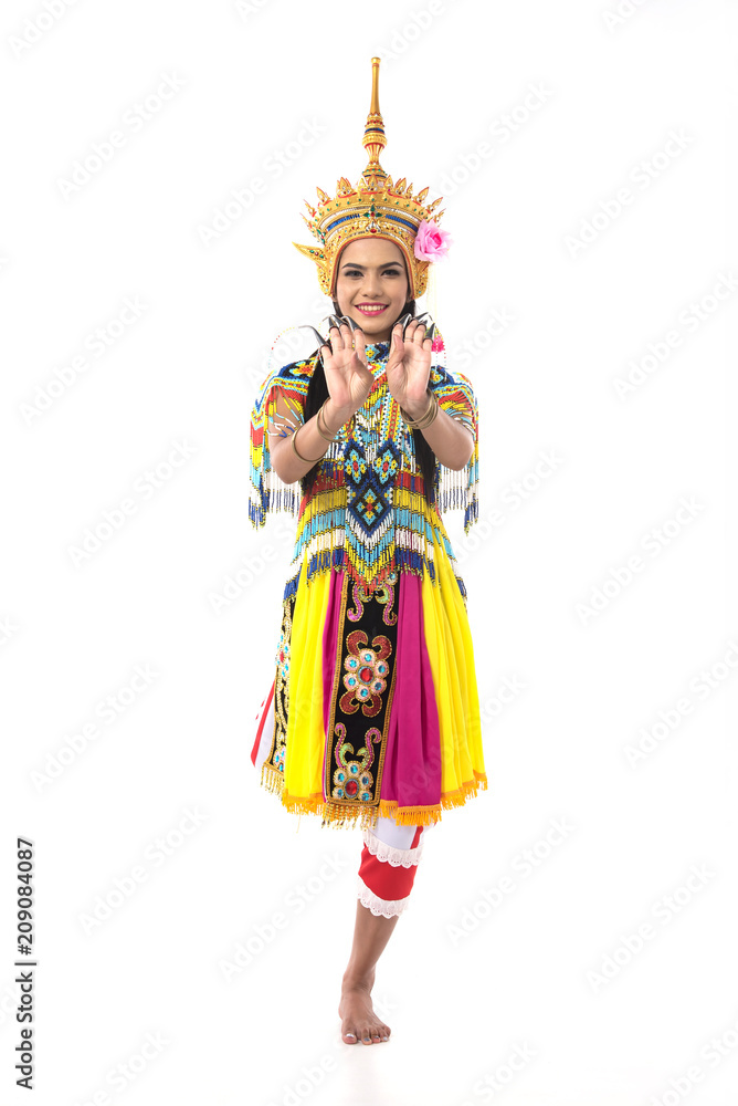 Asian woman in traditional costume of Southern Thailand. Nora dance show.Two hands on the front of the chest. Right leg lifts back.