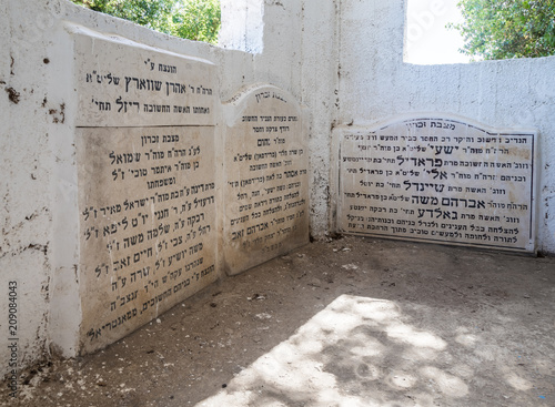 The gravestones with words of gratitude in Hebrew inside the reconstructed tomb Rabbi Nakhman Katufa near the kibbutz Baram in Western Galilee in Israel photo