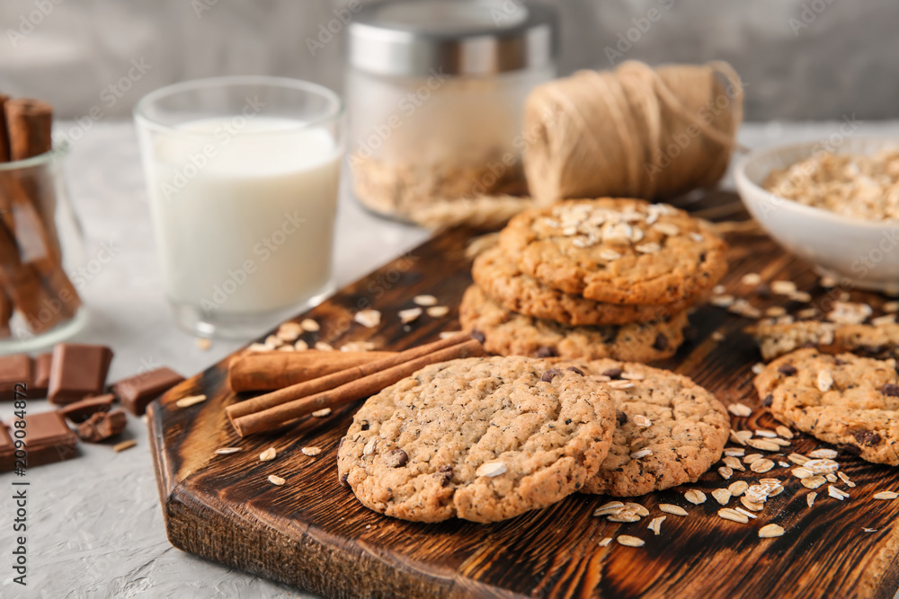 Board with delicious oatmeal cookies on table, closeup Board with delicious oatmeal cookies on table, closeup