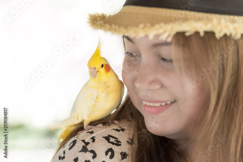 Yellow Cockatoo sitting on woman's shoulder. photo