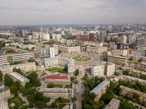 Aerial view of old and new russian buildings near the roundabout in the city with a lot of cars. Russian streets, Novosibirsk.