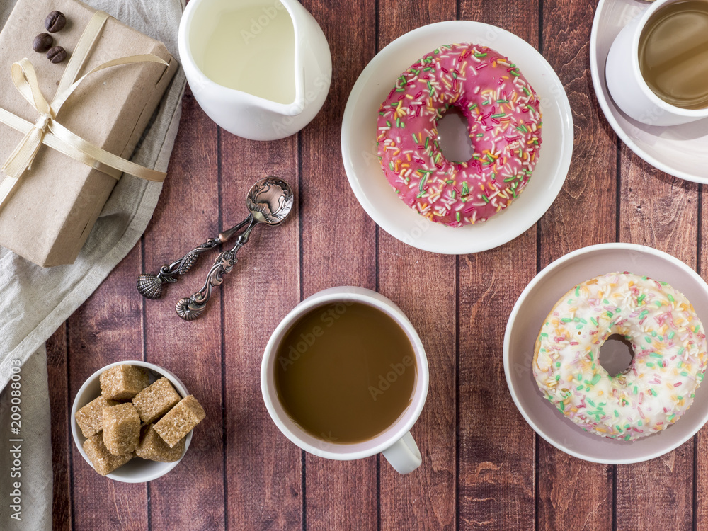 Donuts and coffee on wooden table. Top view with copy space Donuts and coffee on wooden table. Top view with copy space