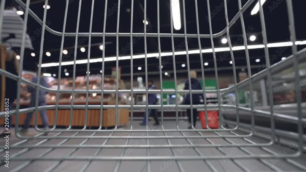Video trolley is moving quickly along aisles in supermarket