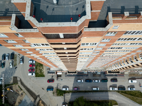 Aerial View of one entrance to skyscraper with parking cars in the city. Dachnaya street, Novosibirsk.