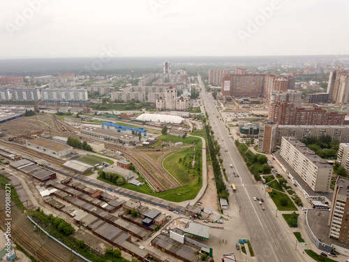 Aerial view of old and new russian buildings with rails and river in the city with a lot of cars. Russian streets, Novosibirsk.