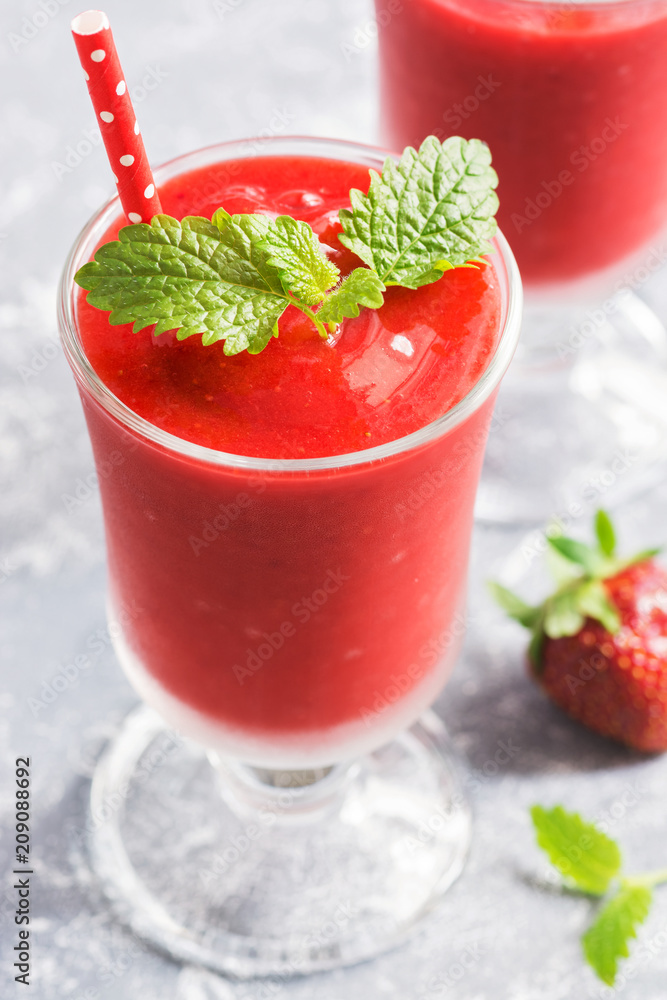 Fresh strawberry smoothies close-up on a light background. Selective focus. Fresh strawberry smoothies close-up on a light background. Selective focus.