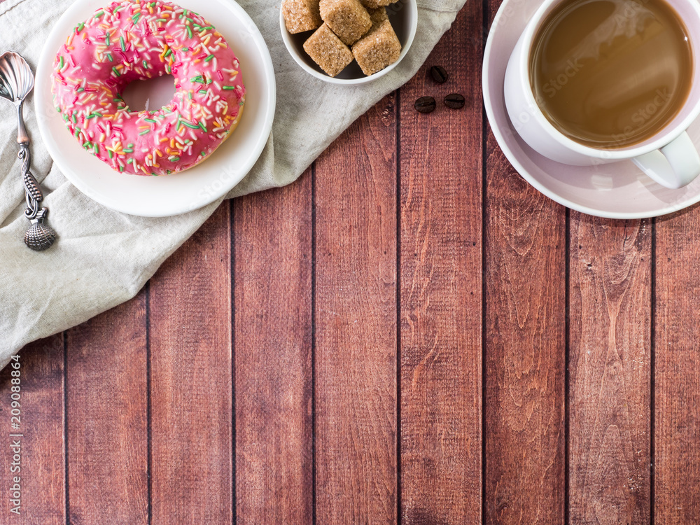 Donuts and coffee on wooden table. Top view with copy space