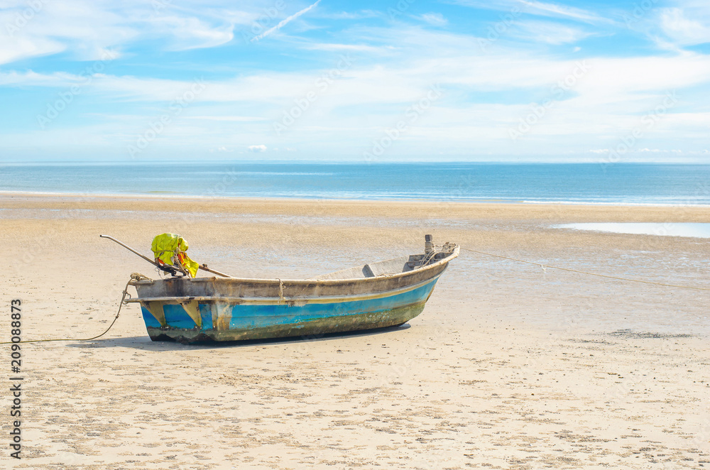 Fishing boat on the tropical beach with blue sky background at Huahin, Thailand