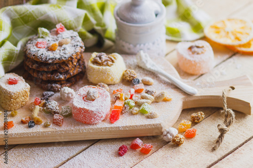 Eastern sweets with fruits, nuts and sugar powder