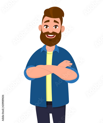 Confident young handsome man keeping arms crossed and smiling while standing .