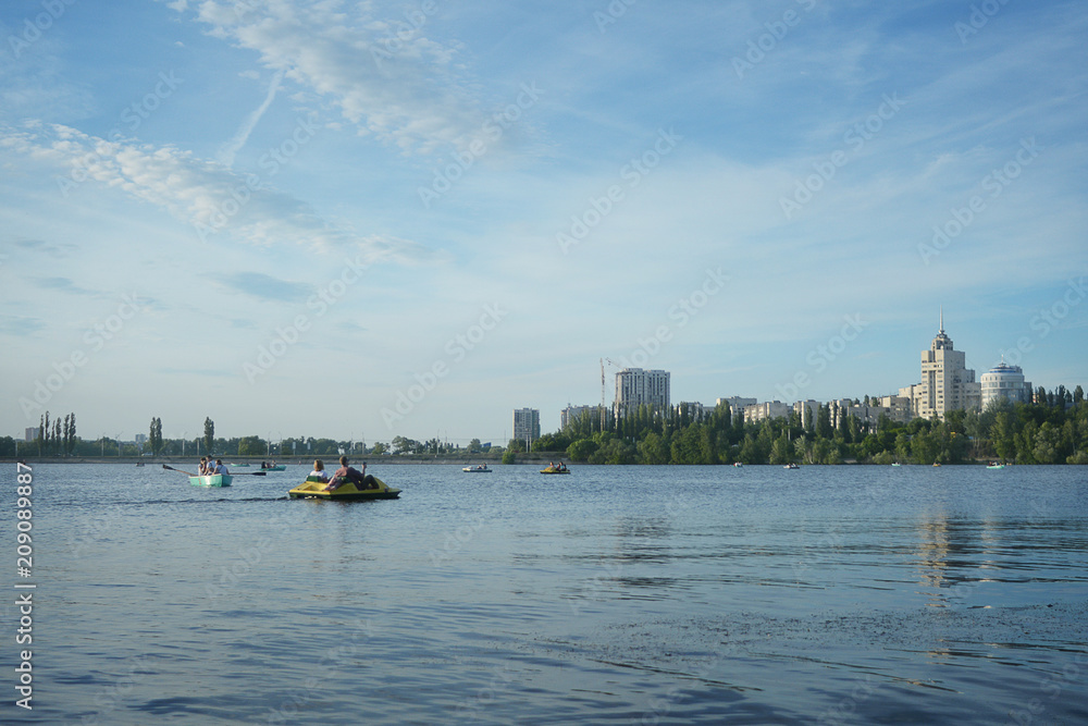 Naklejka premium Walking on a catamaran on a river in the city on a clear day.