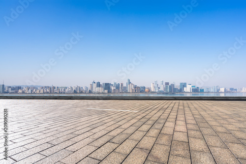 empty  square with panoramic city skyline © THINK b