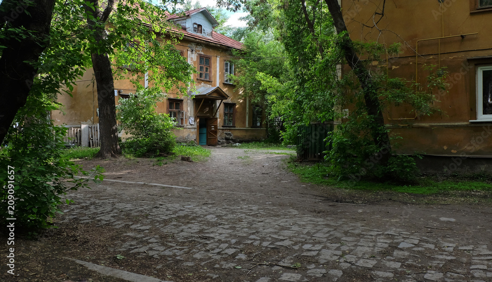 old city courtyard among green trees