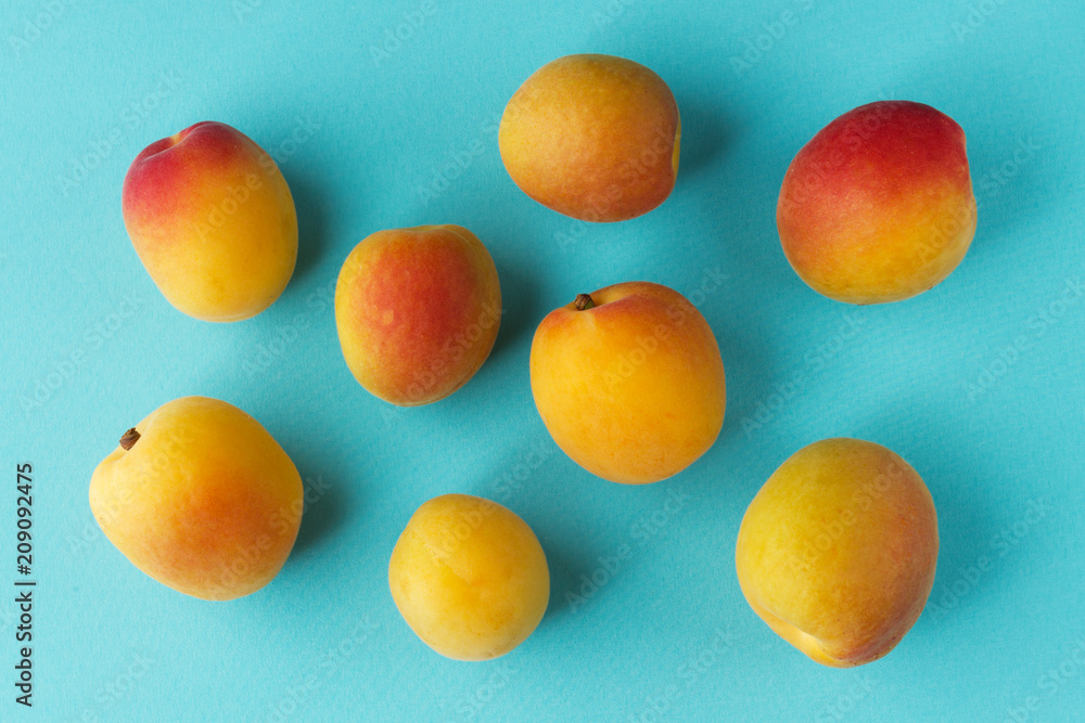 Yellow red apricots on blue background Yellow red apricots on blue background