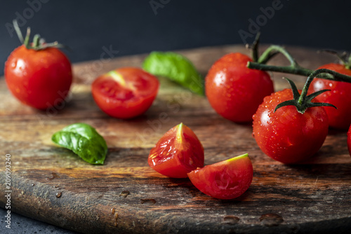 Tomatoes on the vine on wooden board