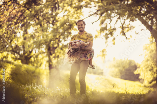 Happy father with his little girl in nature. Time for playing. © liderina