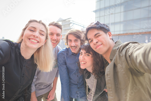 Bilde på lerret Group of young multiethnic friends having fun smiling and making grimace while t